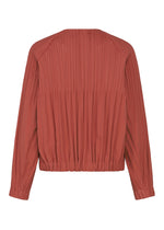 A detail shot of the PLEATS PLEASE ISSEY MIYAKE SMOOTH COAT coat.