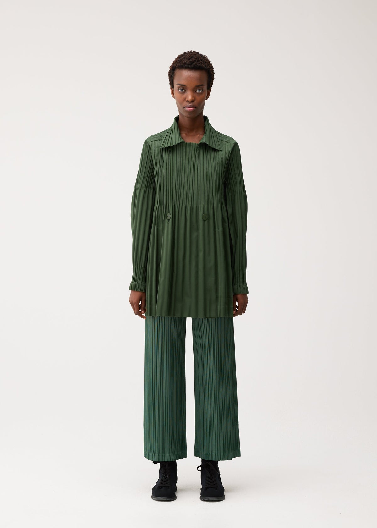 A model wears the PLEATS PLEASE ISSEY MIYAKE SMOOTH COAT smooth-coat-coat-black-3.