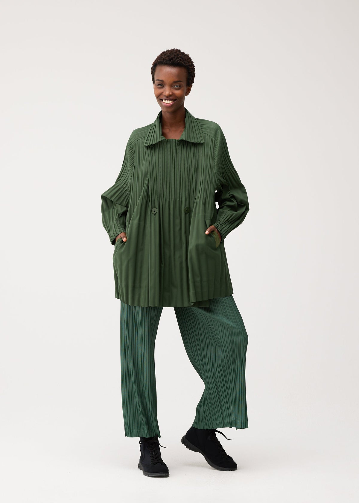 A model wears the PLEATS PLEASE ISSEY MIYAKE SMOOTH COAT smooth-coat-coat-black-3.