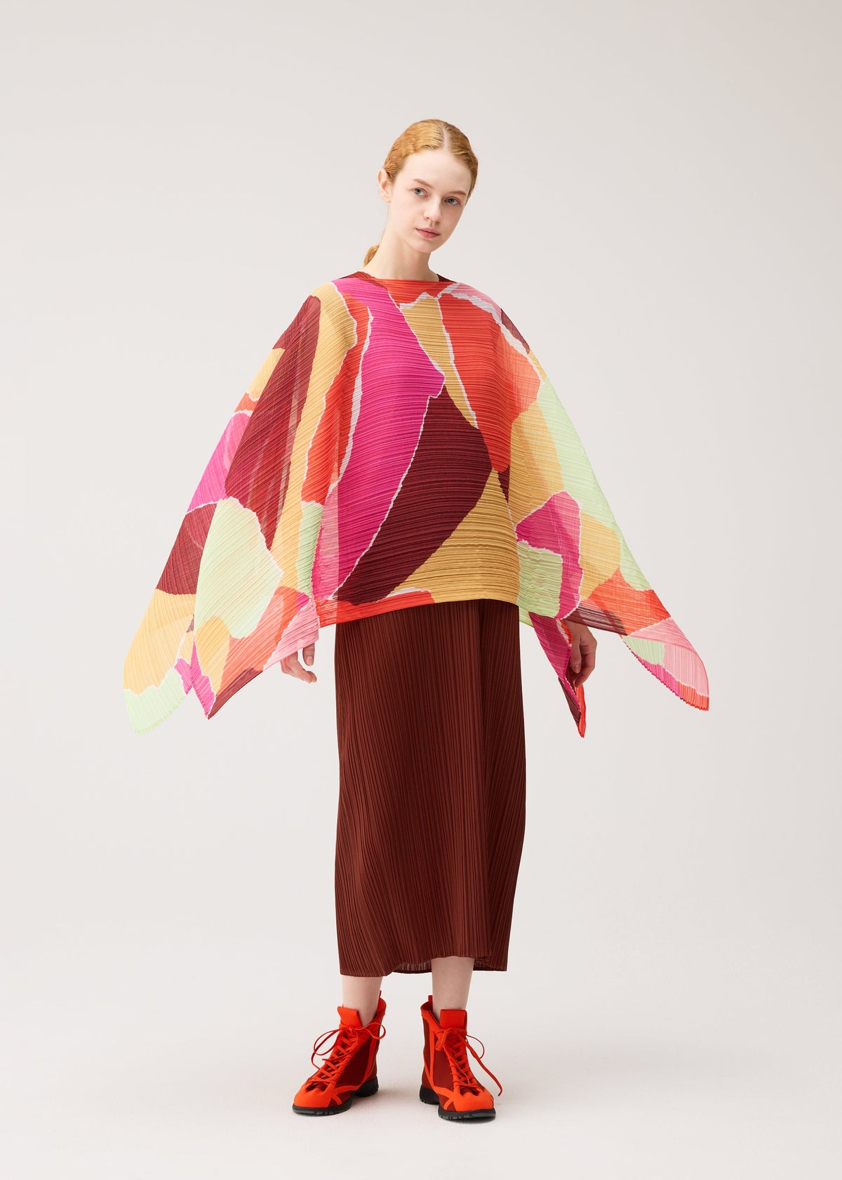A model wears the PLEATS PLEASE ISSEY MIYAKE SURPRISE! MADAME-T surprise-madame-t-stole-purple.