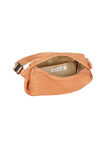 A detail shot of the PLEATS PLEASE ISSEY MIYAKE BIAS PLEATS WAIST BAG bag.