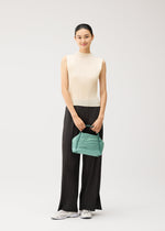 A model wears the PLEATS PLEASE ISSEY MIYAKE BIAS PLEATS BAG bias-pleats-bag-shoulder-bag-light-blue.