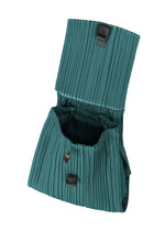 A detail shot of the PLEATS PLEASE ISSEY MIYAKE PLEATS KNAPSACK backpack.